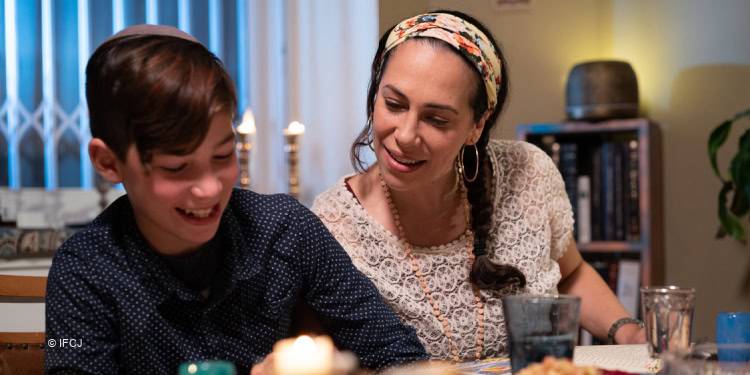 Yael Eckstein and her son sitting at the Passover Seder table.