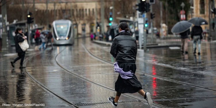 People walking in the rain on Jaffa street in Jerusalem, on February 5, 2025. (Photo: Yonatan Sindel/Flash90)