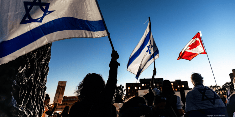people wave Israel and Canada flag