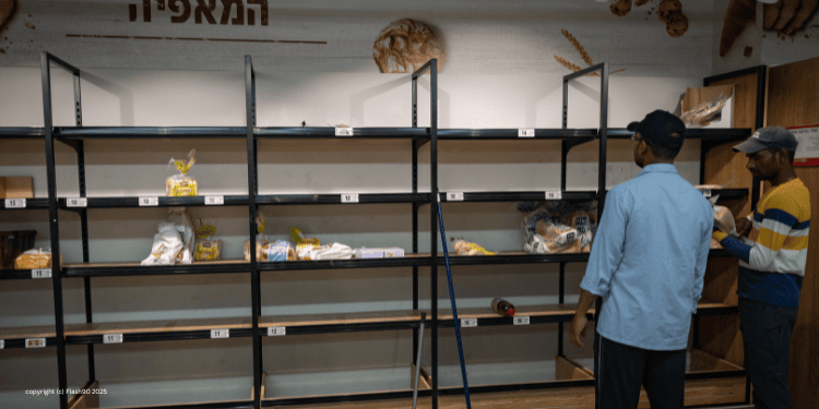 men look at empty grocery store shelves