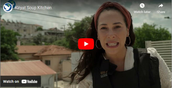 Yael standing outside Kiryat Soup Kitchen, surveying damage