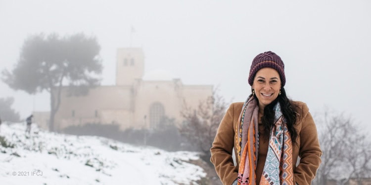 Yael Eckstein walking through the snow in Israel