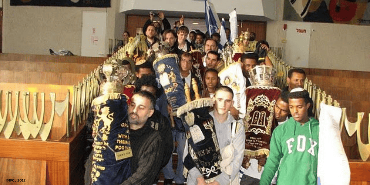 Studenst and Torah scrolls return to the campus of Yemin Orde after the Carmel wildfire.